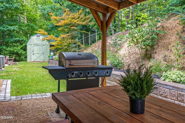 view of patio / terrace featuring area for grilling, a storage unit, cooling unit, and a wooden deck