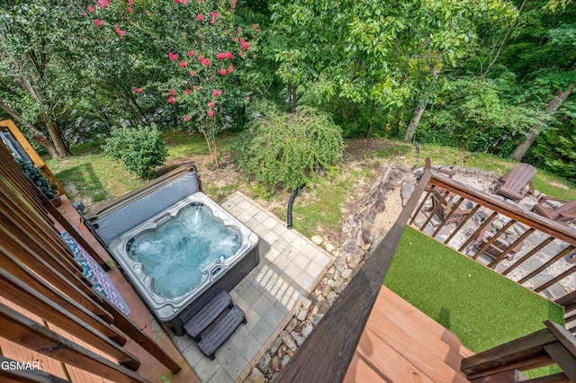 exterior space featuring a covered hot tub and a wooden deck