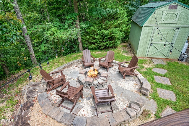 view of patio with a storage unit and an outdoor fire pit