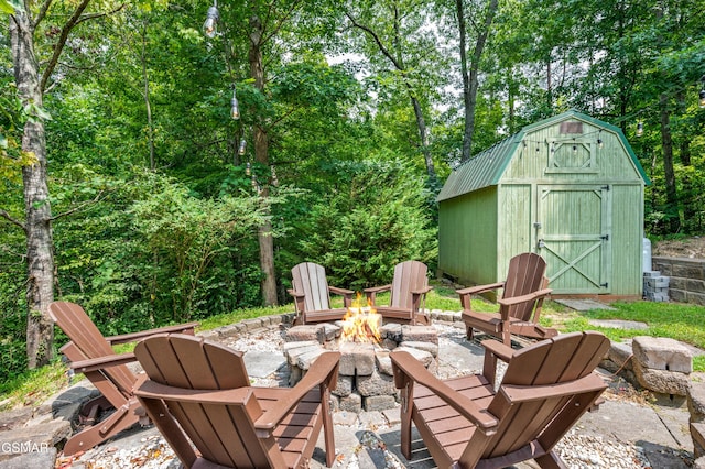 view of patio with a fire pit and a storage unit