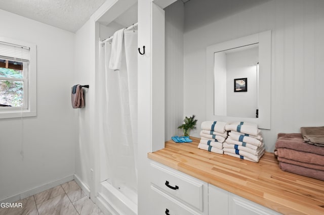 mudroom with a textured ceiling