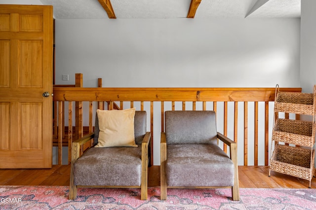 sitting room with a textured ceiling and hardwood / wood-style flooring