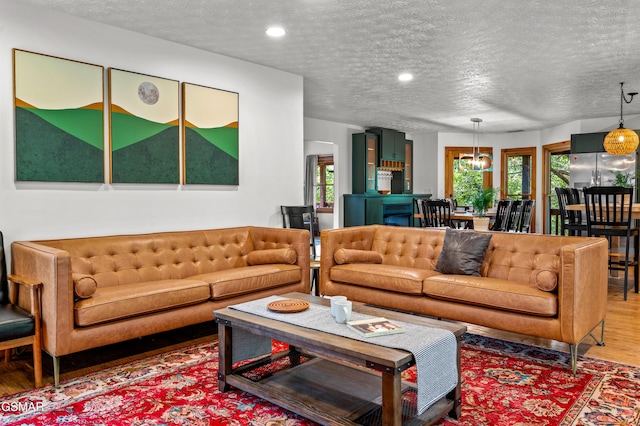 living room with wood-type flooring and a textured ceiling