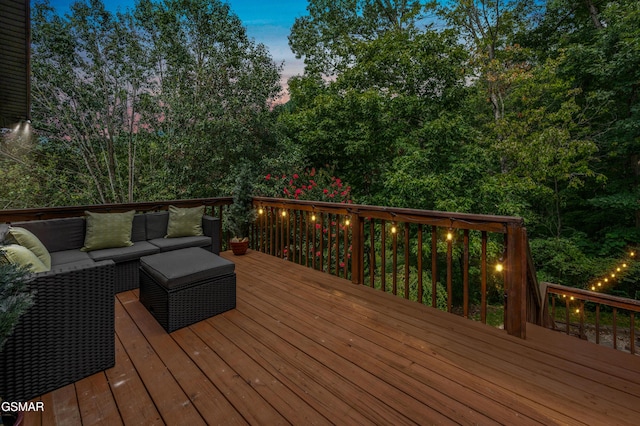 deck at dusk featuring outdoor lounge area