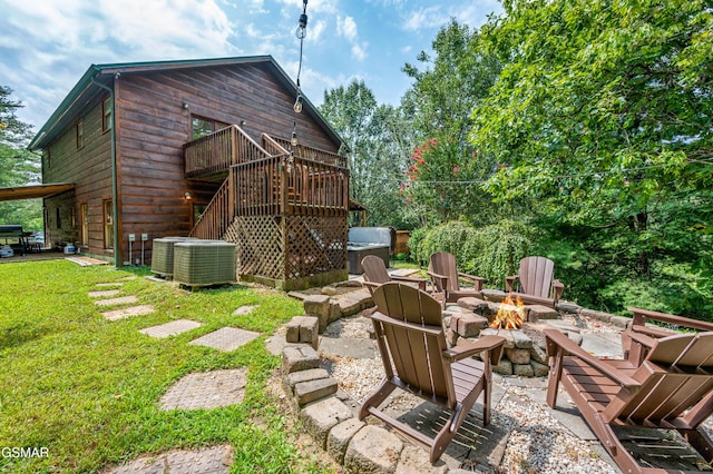 view of patio / terrace with cooling unit, an outdoor fire pit, and a wooden deck