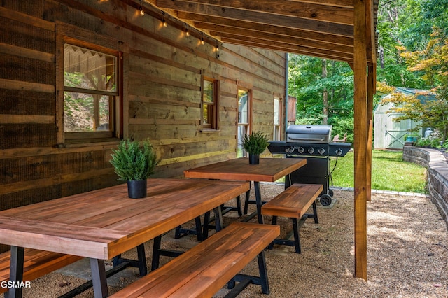 view of patio / terrace featuring a grill and a storage shed