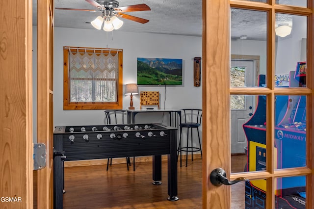 miscellaneous room with ceiling fan, a textured ceiling, and hardwood / wood-style flooring