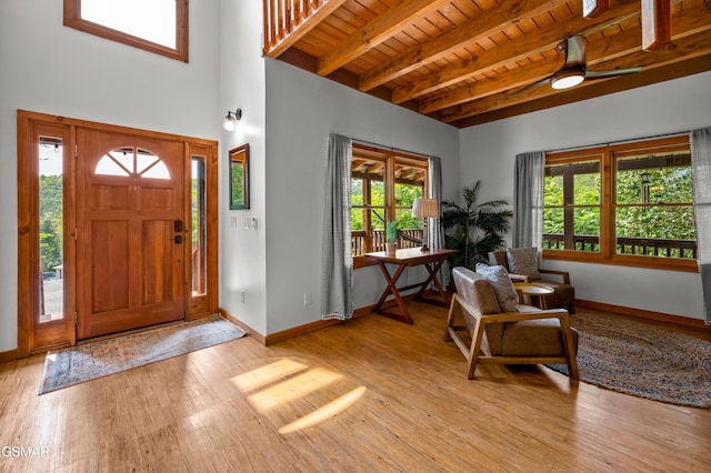 entryway featuring plenty of natural light, beamed ceiling, wood ceiling, and light wood-type flooring