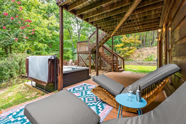 view of patio with a hot tub and a deck