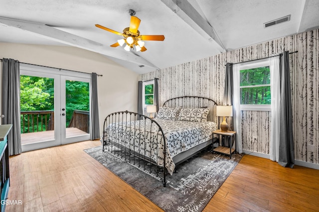 bedroom featuring vaulted ceiling with beams, ceiling fan, wood-type flooring, and access to exterior