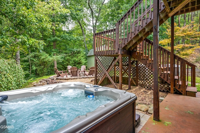 view of swimming pool featuring a hot tub and a deck