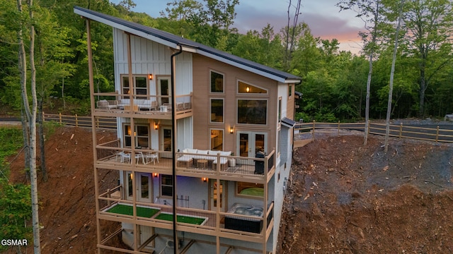 1924 Pine Ct, Sevierville, TN 37876 - back of property with a balcony, board and batten siding, a deck, a forest view, and french doors