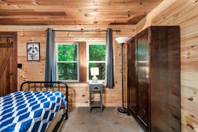 carpeted bedroom featuring wood ceiling and wood walls