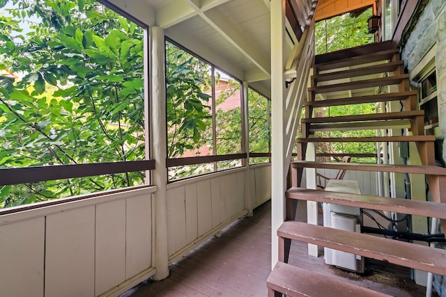 unfurnished sunroom featuring lofted ceiling