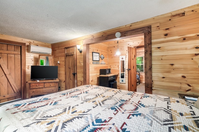 unfurnished bedroom with a wall mounted AC, wooden walls, and a textured ceiling