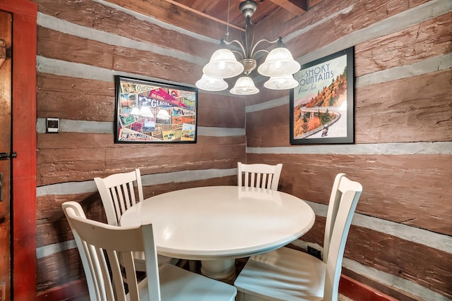 unfurnished dining area featuring a notable chandelier and wood walls