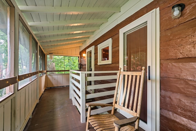 interior space featuring wooden ceiling and lofted ceiling with beams