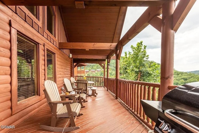 wooden deck featuring covered porch and grilling area