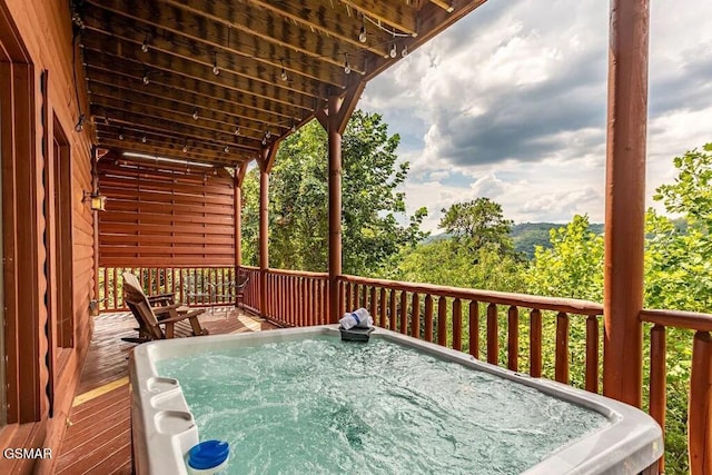 wooden deck with a hot tub