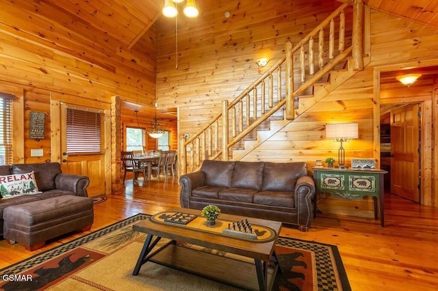 living room with wooden ceiling, high vaulted ceiling, and wood-type flooring