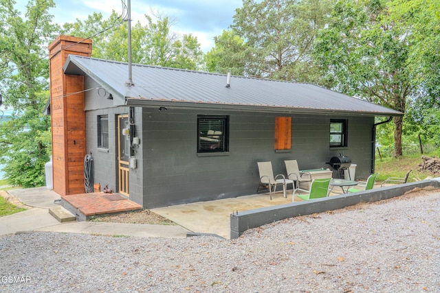 1920 Inskip Ln, Dandridge, TN 37725 - view of front of property with concrete block siding, a chimney, and metal roof