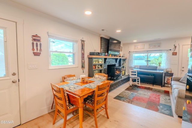 1920 Inskip Ln, Dandridge, TN 37725 - dining space featuring a wood stove, healthy amount of natural light, light wood-style floors, recessed lighting, and ornamental molding
