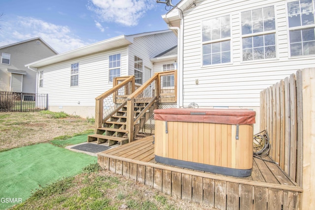 wooden terrace with fence and a hot tub