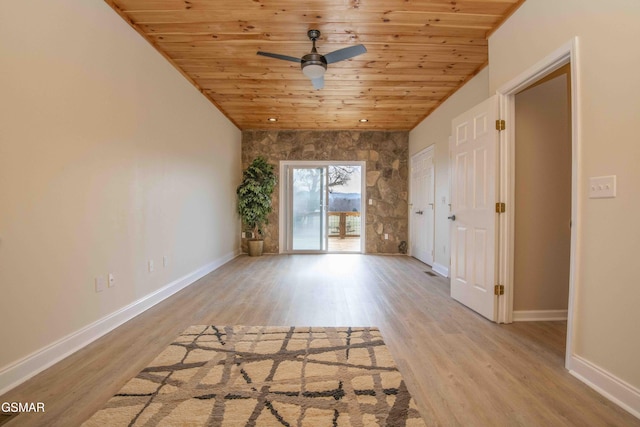 spare room featuring baseboards, lofted ceiling, wooden ceiling, ceiling fan, and wood finished floors