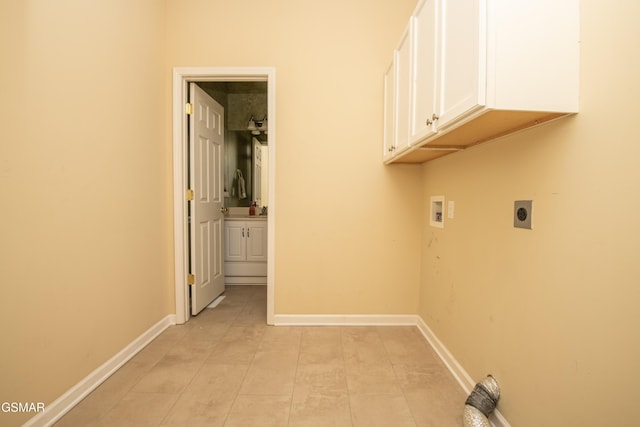 laundry room with light tile patterned floors, hookup for a washing machine, hookup for an electric dryer, baseboards, and cabinet space