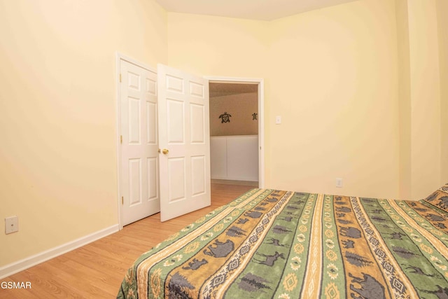 unfurnished bedroom featuring light wood finished floors and baseboards