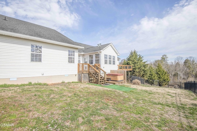 rear view of house with a deck, a shingled roof, fence, crawl space, and a lawn