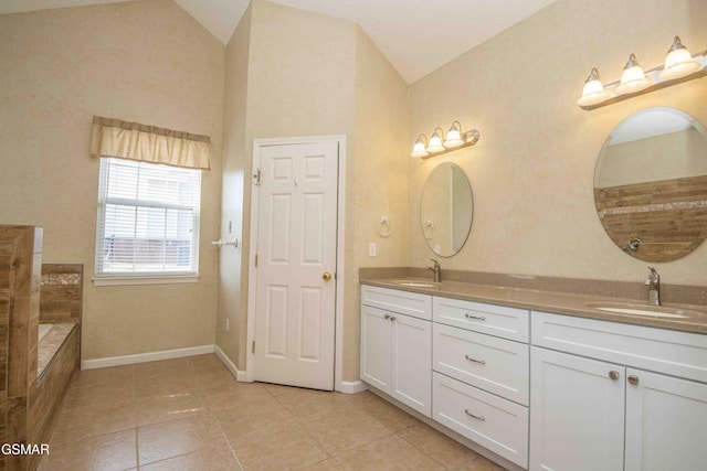 bathroom featuring vaulted ceiling, double vanity, a sink, and tile patterned floors