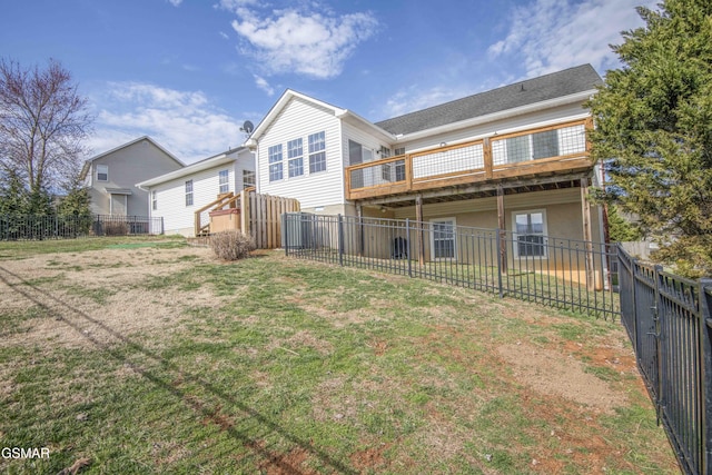 back of house featuring a yard, a fenced backyard, a wooden deck, and stucco siding