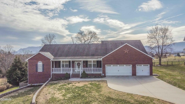 ranch-style home with brick siding, a porch, a front yard, fence, and driveway