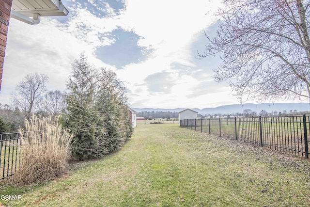 view of yard featuring a rural view and fence