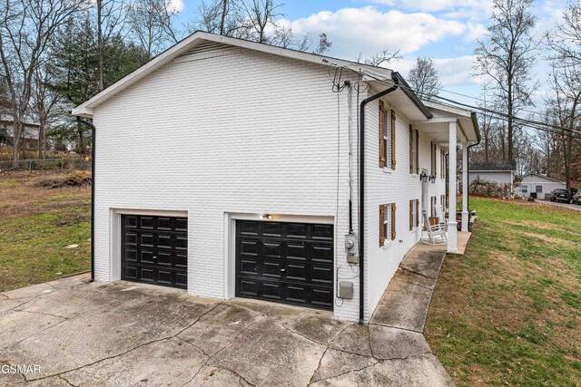 view of property exterior with a lawn and a garage