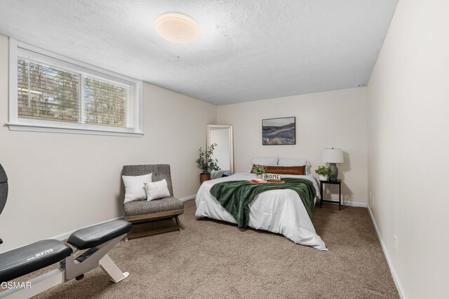 bedroom featuring a textured ceiling and carpet floors