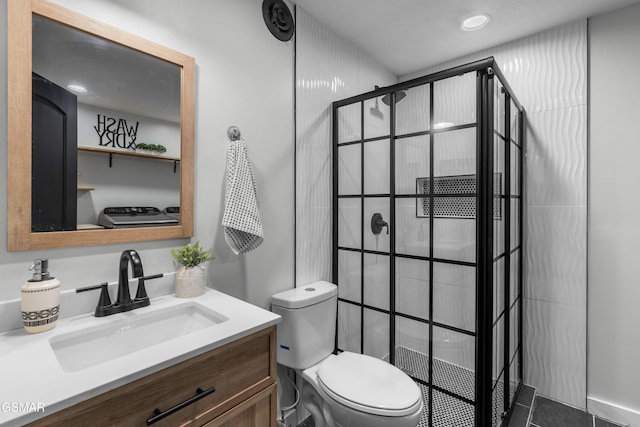 bathroom featuring a shower, tile patterned flooring, vanity, and toilet