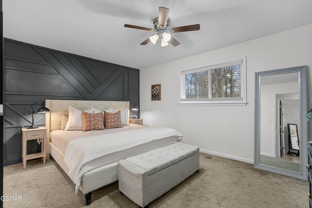 bedroom featuring light carpet and ceiling fan