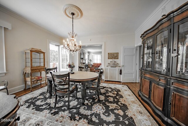 294 Clifton Heights Rd, Newport, TN 37821 - dining area featuring crown molding, baseboards, wood finished floors, and a chandelier