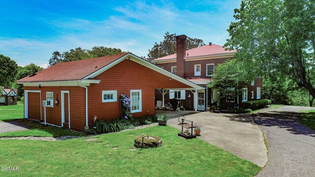 294 Clifton Heights Rd, Newport, TN 37821 - view of front of property with a garage, a chimney, driveway, and a front yard