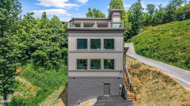 284 Laurel Oaks Way, Gatlinburg, TN 37738 - view of front of house featuring stairway, board and batten siding, and a balcony