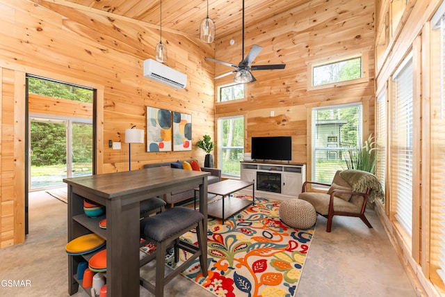5145 E Parkway Pkwy, Cosby, TN 37722 - living area with a wall unit AC, finished concrete floors, a ceiling fan, and wooden walls
