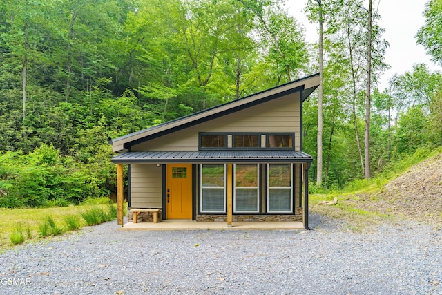 5145 E Parkway Pkwy, Cosby, TN 37722 - view of front of house with a porch, stone siding, a metal roof, and a forest view