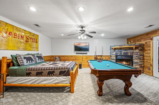 rec room with wood walls, carpet, and a textured ceiling