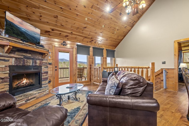 living room with ceiling fan, high vaulted ceiling, wooden ceiling, a fireplace, and hardwood / wood-style floors