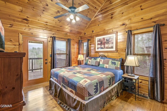 bedroom featuring access to exterior, ceiling fan, multiple windows, and vaulted ceiling