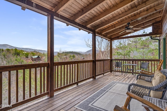 deck featuring a mountain view and ceiling fan