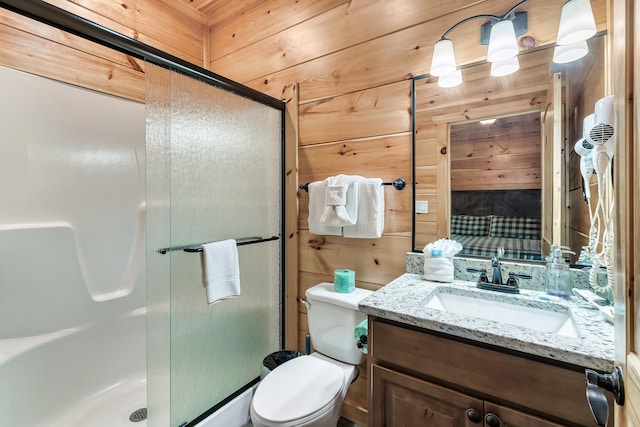 bathroom with wood walls, vanity, an enclosed shower, and toilet