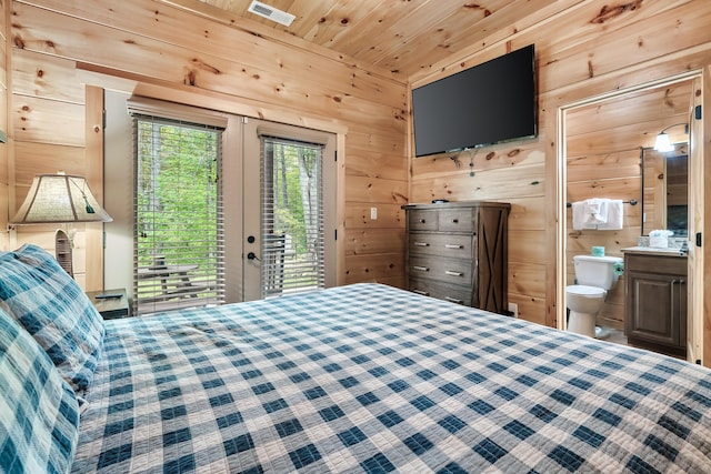 bedroom with wooden ceiling, access to outside, ensuite bath, and wooden walls